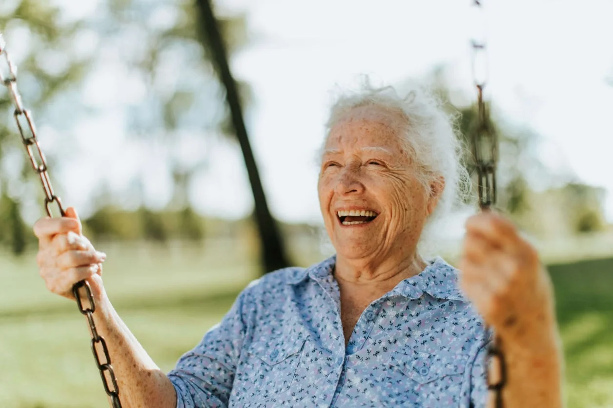 A smiling older woman enjoying time outdoors
